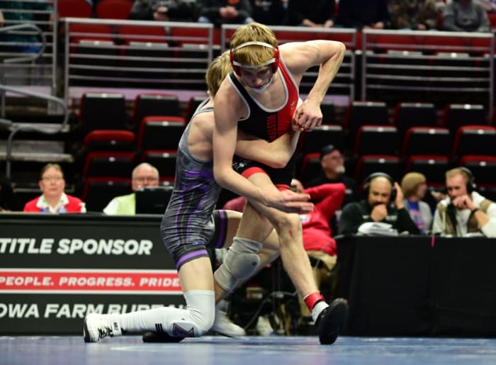 Akron-Westfield's Cael Morrow (near) tries to escape a hold by Baxter's Ayden Beck during a Class 1A semifinal match at 120 pounds during the Iowa high school state wrestling tournament at Wells Fargo Arena in Des Moines on Friday. (Photo by Ryan Timmerman)